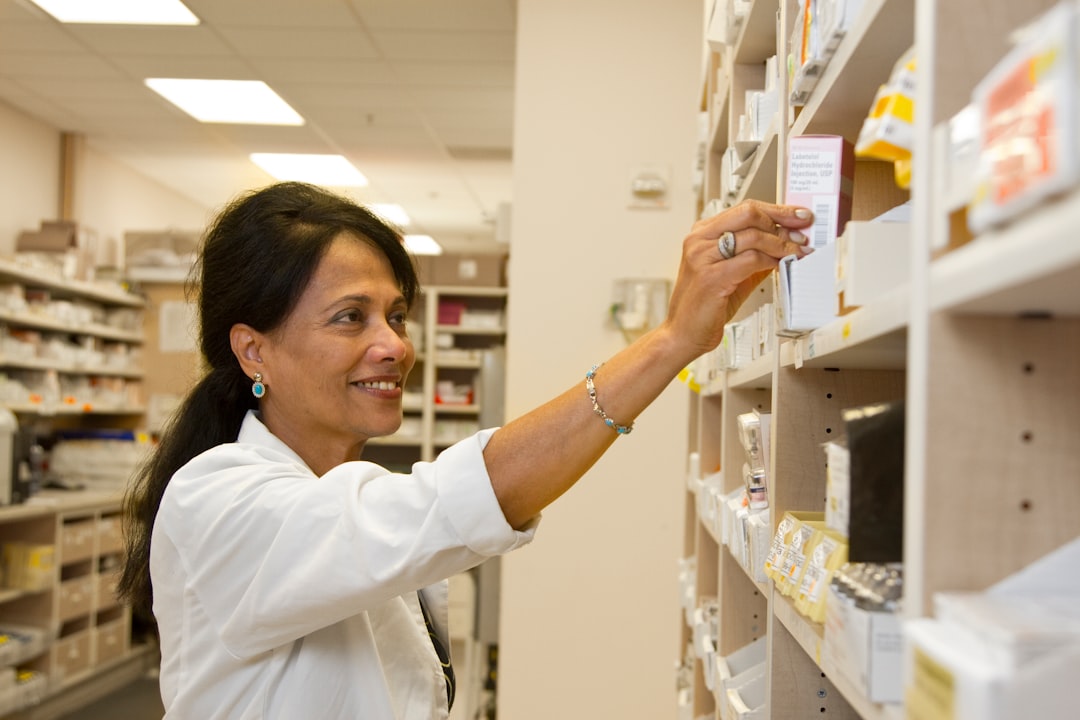 A pharmacist carefully selecting medication for a customer